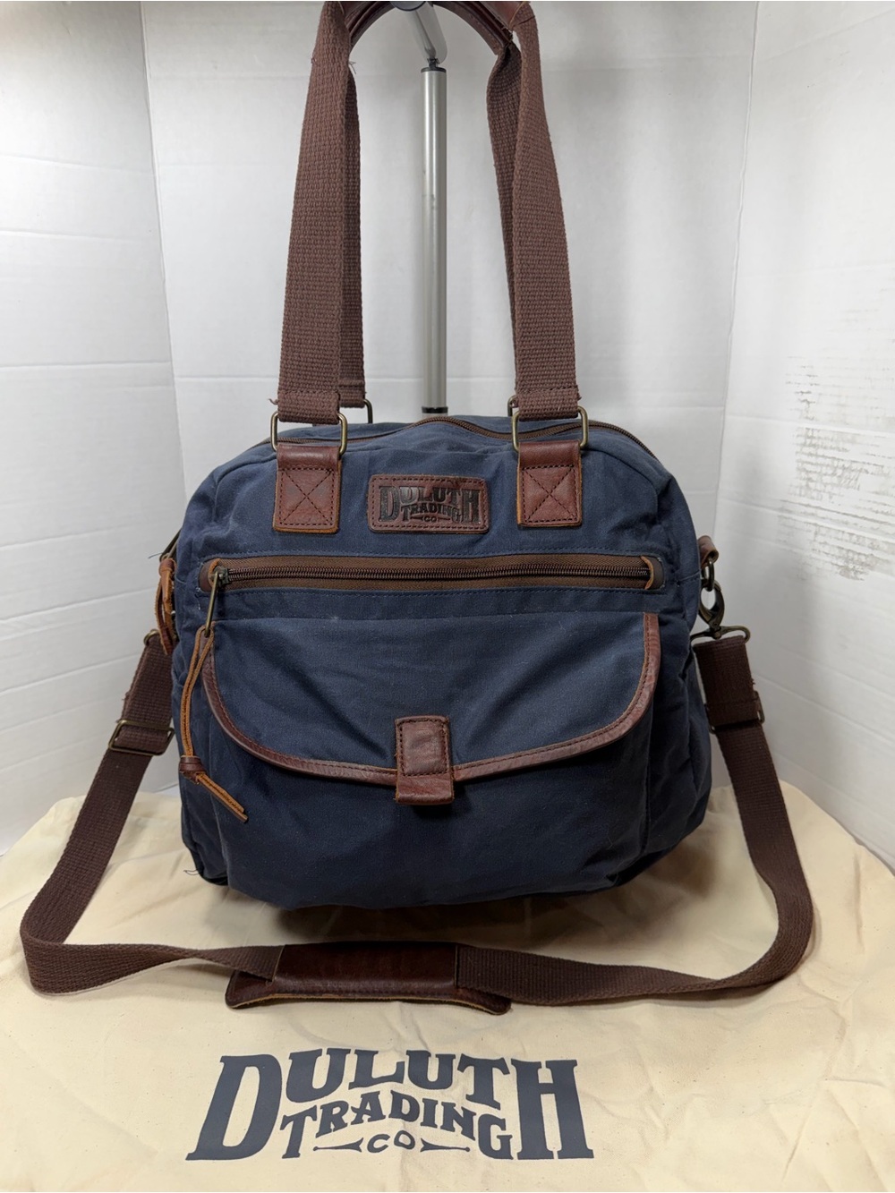 Duluth Trading Co Navy Canvas Messenger Bag with Brown Trim comes with dust bag